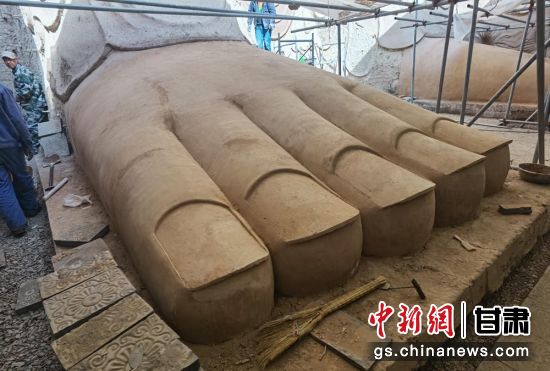 圖為中國“石窟鼻祖”天梯山石窟第13窟大佛足部與局部危巖體搶救性保護項目施工現(xiàn)場。陳曉斌 攝