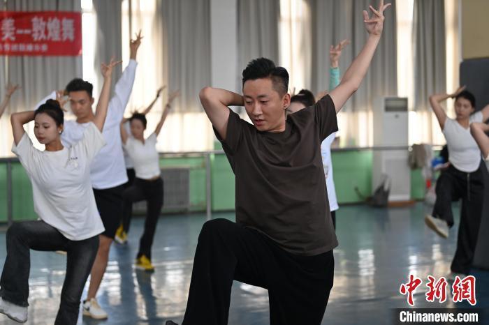 6月6日，在甘肅敦煌青年夜校課程中，青年學(xué)員學(xué)習(xí)敦煌舞課程。李亞龍 攝　　